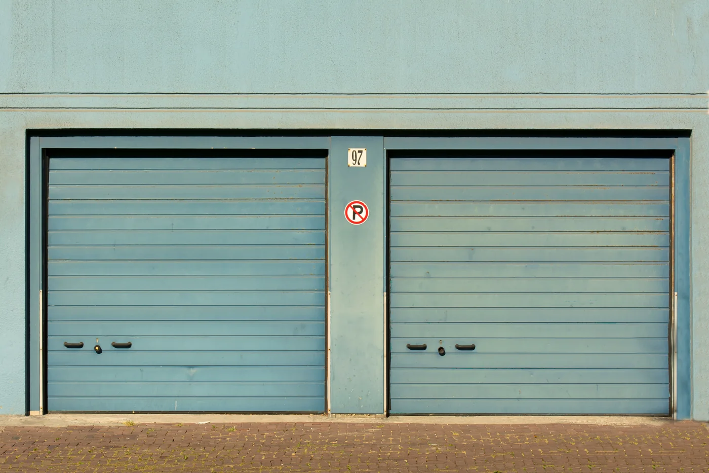 Garage doors installed along a clean building exterior